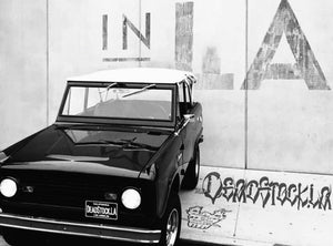 Black 1966 Ford Bronco in front of a LA mural 